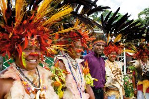 Dominic (purple shirt) with villagers wearing traditional dress. Photo: Supplied