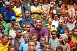 Dominic (centre with purple shirt) with fellow villagers. Dominic is facilitating discussing in his community about the challenges they face having learnt facilitation and problem solving skills through the Community Conversations program. “I am most proud of the positive changes I am witnessing,” says Dominic. Photo: Supplied