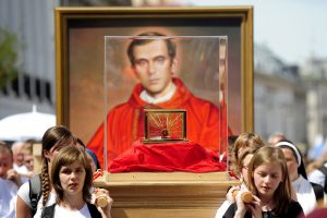 Young women carry a relic of Blessed Jerzy Popieluszko, a priest who was murdered by communist police agents in 1984, through the streets of Warsaw, Poland. Young women carry a relic of Blessed Jerzy Popieluszko, a priest who was murdered by communist police agents in 1984, through the streets of Warsaw, Poland.