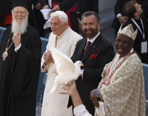 Ecumenical Patriarch Bartholomew of Constantinople, Pope Benedict XVI, Rabbi David Rosen and Wande Abimbola, representative for the Yoruba religion of Nigeria, smile as a dove is held up during the interfaith meeting for peace outside the Basilica of St. Francis in Assisi, ItalyEcumenical Patriarch Bartholomew of Constantinople, Pope Benedict XVI, Rabbi David Rosen and Wande Abimbola, representative for the Yoruba religion of Nigeria, smile as a dove is held up during the interfaith meeting for peace on Oct. 27 2012 outside the Basilica of St. Francis in Assisi, Italy. PHOTO: CNS/Paul Haring Ecumenical Patriarch Bartholomew of Constantinople, Pope Benedict XVI, Rabbi David Rosen and Wande Abimbola, representative for the Yoruba religion of Nigeria, smile as a dove is held up during the interfaith meeting for peace outside the Basilica of St. Francis in Assisi, ItalyEcumenical Patriarch Bartholomew of Constantinople, Pope Benedict XVI, Rabbi David Rosen and Wande Abimbola, representative for the Yoruba religion of Nigeria, smile as a dove is held up during the interfaith meeting for peace on Oct. 27 2012 outside the Basilica of St. Francis in Assisi, Italy. PHOTO: CNS/Paul Haring