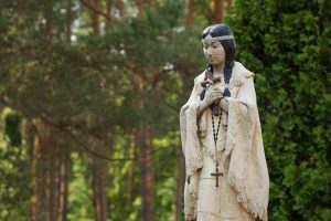 A statue of Blessed Kateri Tekakwitha stands amid trees on the grounds of the shrine dedicated to her in Fonda, N.Y., July 14, her U.S. feast day.