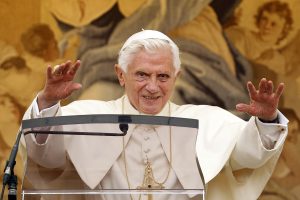 Pope Benedict XVI waves as he leads the Angelus from a window at the papal summer residence in Castel Gandolfo, Italy