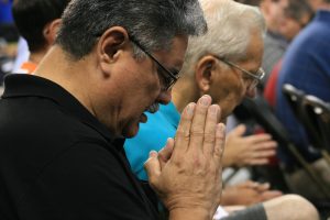 Alfonso G. Martinez Jr., a member of St. Patrick Parish in Fremont, Neb., prays the Our Father Aug. 4 at the Archdiocese of Omaha's third annual Heartland Catholic Men's Conference at D.J. Sokol Arena on the Creighton University campus in Omaha, Neb. Alfonso G. Martinez Jr., a member of St. Patrick Parish in Fremont, Neb., prays the Our Father Aug. 4 at the Archdiocese of Omaha's third annual Heartland Catholic Men's Conference at D.J. Sokol Arena on the Creighton University campus in Omaha, Neb.