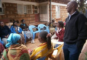 Jesuit Father Stephen Nzioki, program director of Uzima’s self-help group, jokes with members at the centre. Jesuit Father Stephen Nzioki, program director of Uzima’s self-help group, jokes with members at the centre.