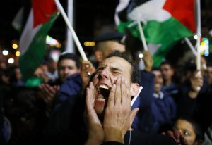 A Palestinian man reacts during a rally in the West Bank city of Ramallah on November 29 when the UN General Assembly approved a resolution to grant Palestine observer status, implicitly recognising a Palestinian state.