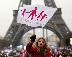 A demonstrator waves a flag on the Champ de Mars near the Eiffel Tower in Paris on January 13 to protest against France’s planned legalisation of same-sex marriage. PHOTO: Charles Platiau, Reuters, CNS