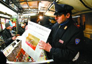 Coming to terms: A policeman holds a copy of L'Osservatore Romano newspaper in Rome Feb. 11. PHOTO: CNS/Giampiero Sposito, Reuters Coming to terms: A policeman holds a copy of L'Osservatore Romano newspaper in Rome Feb. 11. PHOTO: CNS/Giampiero Sposito, Reuters