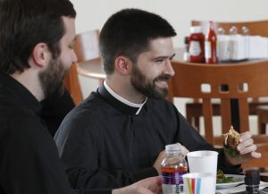 Deacon Dustin Dought, who is studying to be a priest for the Diocese of Lafayette, La., shares a light moment with other seminarians on Feb. 28 at Theological College in Washington. PHOTO: CNS/Bob Roller