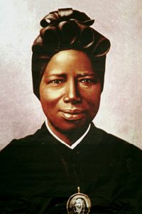 A tapestry portrait of St Josephine Bakhita, an African slave who died in 1947, hangs from the facade of St Peter's Basilica during her canonisation in 2000 at the Vatican. St Bakhita was born in the Darfur region of what is now Sudan. Photo: CNS/L'Osservatore Romano via Reuters.