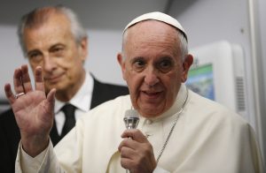 Pope Francis answers questions from journalists aboard his flight from Asuncion, Paraguay, to Rome July 12. PHOTO: CNS/Paul Haring