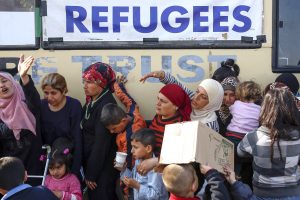 People wait to receive food at a makeshift camp for migrants and refugees on 6 April at the Greek-Macedonian border near the village of Idomeni, Greece. Pope Francis will go to the Greek island of Lesbos on 16 April with Orthodox leaders to highlight the plight of refugees. Photo: CNS/Marko Djurica