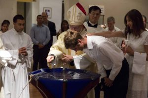 The congregation hold their candles during the liturgy of light at the commencement of the Easter Vigil at St Mary’s Cathedral on 26 March 2016. Photo: Ron Tan.