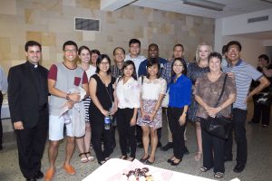 Bateman Assistant Parish Priest Fr Christian Irdi with candidates and catechumens at the social gathering following the Rite of Election ceremony at St Mary’s Cathedral. Photo: Ron Tan