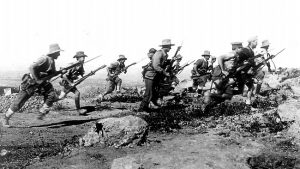 Australian soldiers at Anzac Cove in 1915 enact a charge for the official photographer. PHOTO: Australian War Memorial/Supplied