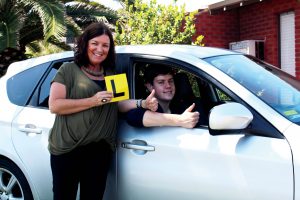 Time to finally hit the road: A newbie L plater, Callan is refining his driving skills with the help of Identitywa Family Support worker, Andrea. Callan hopes to one day drive V8 Super cars. Photo: Supplied