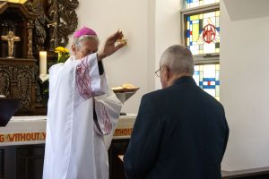 Mercedes College students and their grandparents receive a message about the importance of looking after others during Father Brennan Sia’s homily. Photo: Feby Plando.