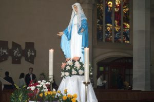 Student from Trinity College bonds over technology and the mysterious ways of the iPad with a resident at Archbishop Goody Hostel. PHOTO: Supplied