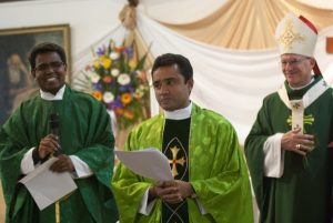 Fr Johnson, Fr Mathew and Archbishop Timothy Costelloe take a moment of jubilation as Fr Mathew is installed as the new parish priest at St Jerome's in Spearwood.
