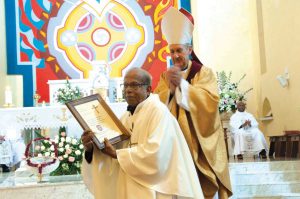 Archbishop Emeritus Hickey presents Fr Julian Carrasco with a special certificate in recognition of and gratitude for his pastoral services to the Portuguese community of Australia in 2014. Fr Julian passed away on Saturday, 11 July at Fiona Stanley Hospital after a long battle with ill health. PHOTO: Mat De Sousa