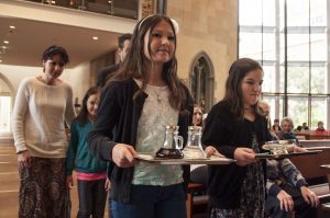 Perth woman Michelle Firth, far left, and family take up the gifts to Bishop Don during the Mass for Pregnancy Assistance at St Mary's Cathedral on April 18. PHOTO: Mat De Sousa
