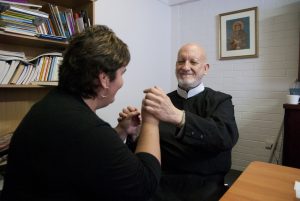 Deaf interpreter, Patricia Levitzke-Gray, communicates questions from Record journalist Mark Reidy to Fr Cyril Axelrod during an interview at The Record's offices.