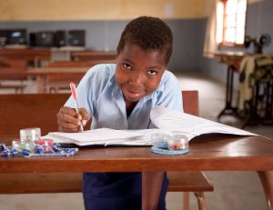 Ditosa Souza Sitoe 12 years, writing in the common room in the community centre in Matuba, Mozambique. PHOTO: Erin Johnson, Caritas Australia. Ditosa Souza Sitoe 12 years, writing in the common room in the community centre in Matuba, Mozambique. PHOTO: Erin Johnson, Caritas Australia.