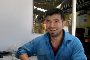 Mechanic Mustafa Jawadi at work with Nat McGahey. Photo: Supplied.