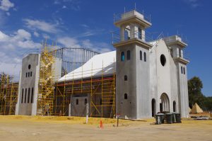 The Romanesque-looking Divine Mercy Church at Maryville Downs near Lower Chittering takes shape and, below, an artist’s impression of the finished structure