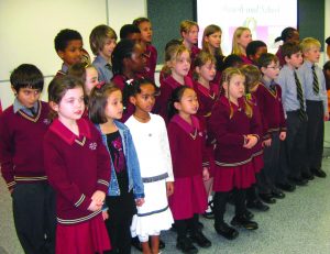 School children singing in the hall on the Feast Day of Santa Clara celebrated at the Santa Clara Church in Bentley. PHOTO: Glynnis Grainger