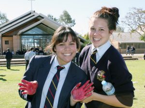 Students of Kolbe Catholic College in Rockingham get their hands dirty painting a banner, raising awareness for LifeLink.