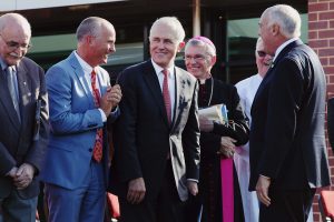 Archbishop Costelloe holds up the crosses before blessing them for the new Brother Fitzhardinge Trade Skills Centre at La Salle College, which was officially blessed and opened on Wednesday, 13 April. Photo: Jesse Roberts