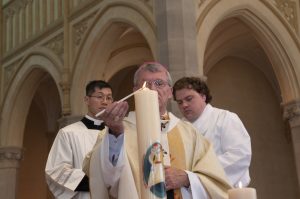 At the conclusion of the Mass, Archbishop Costelloe lit the Year of Mercy candle to commemorate the inauguration of the Jubilee Year. Photo: Marco Ceccarelli.