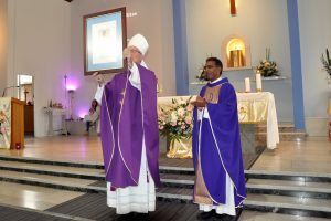 Auxiliary Bishop Don Sproxton holds a Papal Blessing next to parish priest Fr Arulraj Mulaguri at the 80th anniversary mass at Our Lady Help of Christians. Photo: Supplied.