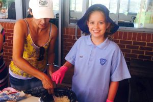 Year 6 student leader Kyla Clark serves rice with a parent helper at one of Our Lady of Fatima Primary School’s Rice Days, which were held every Friday during Lent. Photo: Supplied