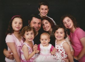 Former steelworker Michael Siciliano with several of his granddaughters. Mr Siciliano. After seeing Fr Rea on October 12 at St MAry’s Cathedral in Perth Mr Siciliano is adament he no longer experiences severe back pain.