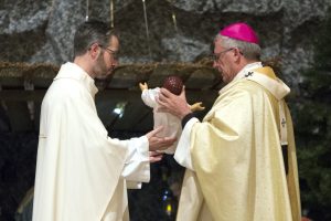 Dean of St Mary’s Cathedral Monsignor Michael Keating pictured with Ralph and Luanne Alegre and their son Liam Antonio, who was the Infant Jesus during the Children’s Mass. Photo: Ron Tan