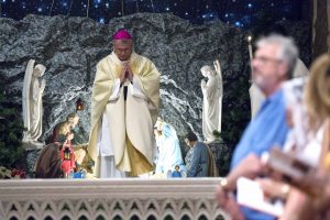 Archbishop Timothy Costelloe kneels in front of the Nativity during the Midnight Mass at St Mary’s Cathedral on Thursday 24 December 2015. The Cathedral was last month overwhelmed with visitors and regular parishioners as the local community from far and wide came together to celebrate the birth of Christ. Photo: Ron Tan.