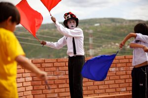 Raymundo Ramos (22), teaches children acting and circus skills on the roof of Wasy Tukuypaj. PHOTO: CARITAS