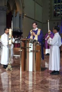 Deacon Matthew Hodgson proclaims the Gospel at the Mass held at St Mary’s Cathedral on Saturday, 12 December to celebrate the Opening of the Holy Door, marking the commencement of the Jubilee Year of Mercy. Photo: Jamie O’Brien