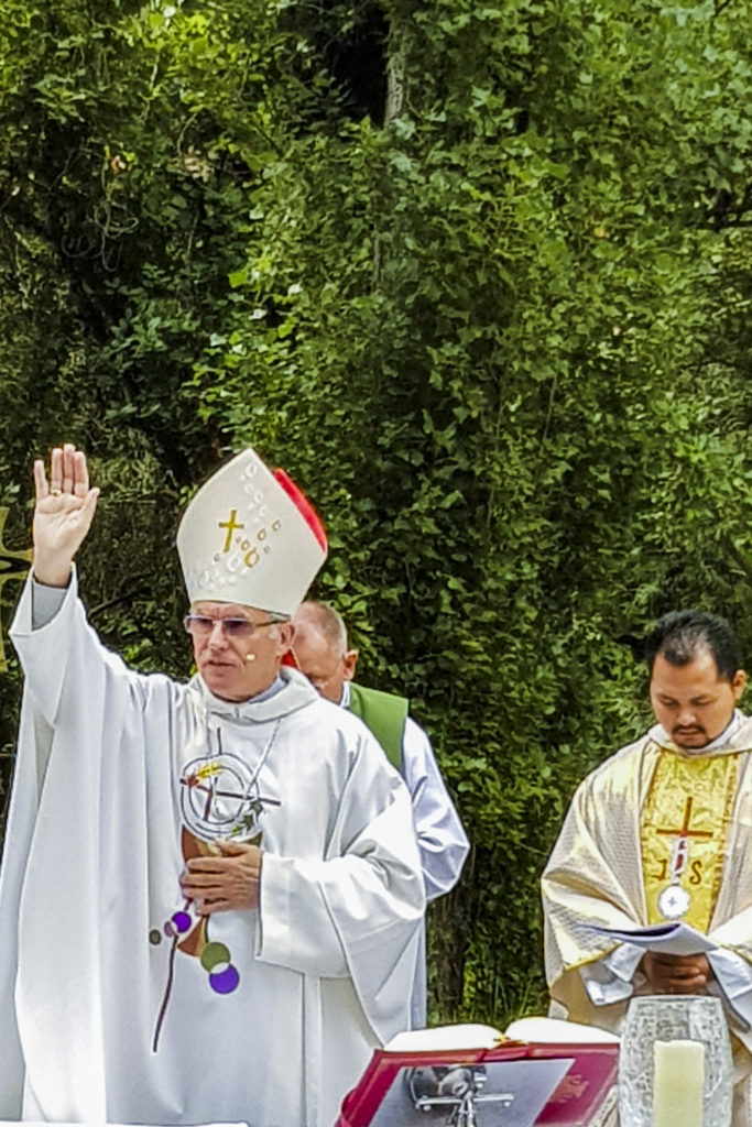 Archbishop Costelloe bestows a blessing on those present for the investiture on 12 February in grounds of Lesmurdie House on campus, with the Mercy Heritage Cottage as the backdrop. Photo: Supplied.