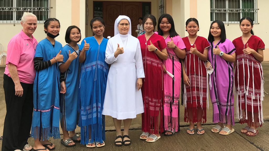 Sister Francis Hayes with a group of young women and a fellow nun teacher