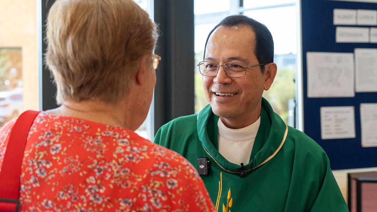 Bishop-Elect Po greets a parishioner at St Benedict's Church, Applecross.