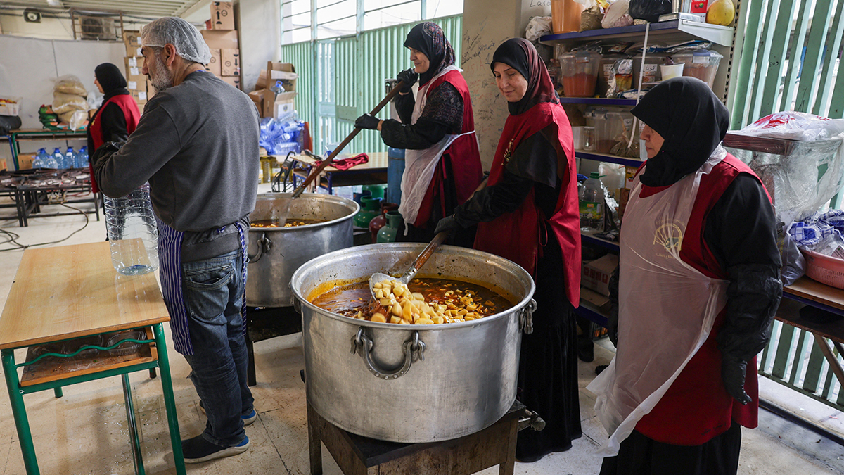 People cook at a school turned into a shelter for displaced families in Beirut 16 March 2026, following an escalation of aerial attacks between Hezbollah and Israel, amid the U.S.-Israeli war with Iran. Photo: OSV News/Khalil Ashawi, Reuters.