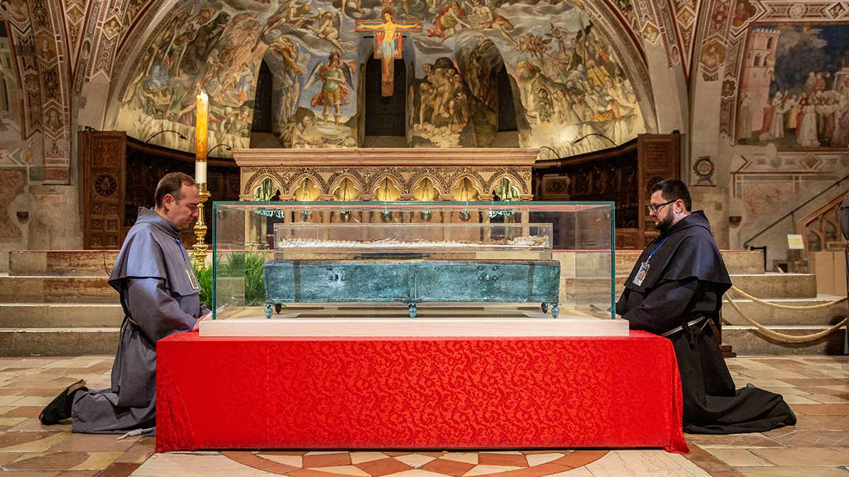 Franciscan friars kneel in prayer during the final moment of veneration of the relics of St. Francis of Assisi on 22 March 2026, in the Lower Church of the Basilica of St. Francis of Assisi. Photo: OSV News/Basilica of St. Francis of Assisi.