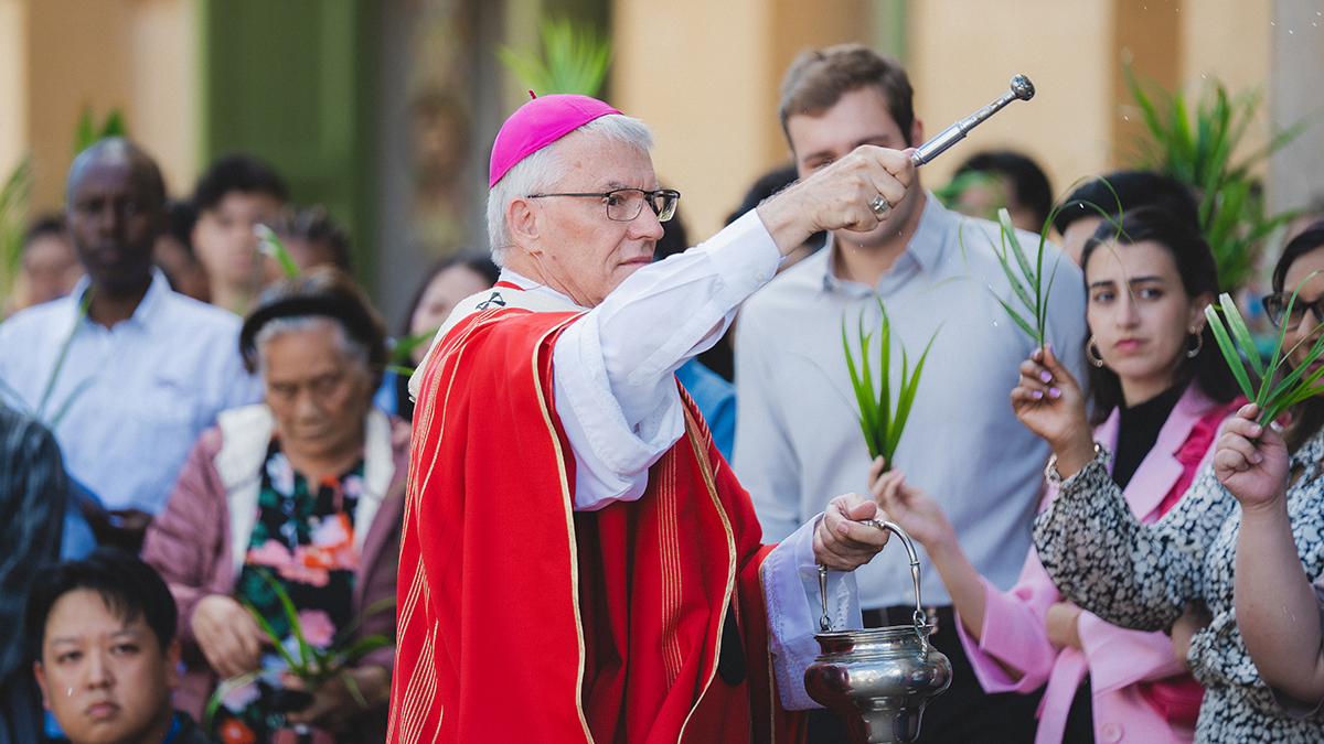 Archbishop Costello blesses the palms during Palm Sunday Mass.