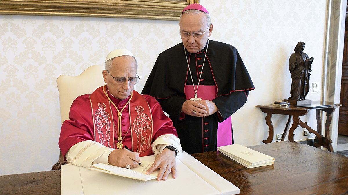 Pope Leo XIV signs his first apostolic exhortation, ‘Dilexi Te’ (‘I Have Loved You’), in the library of the Apostolic Palace at the Vatican on 4 October 2025. His first encyclical, ‘Magnifica Humanitas,’ addressing artificial intelligence and the protection of human dignity, will be published on 25 May 2026 the Vatican announced on 18 May. Photo: CNS/Vatican Media.