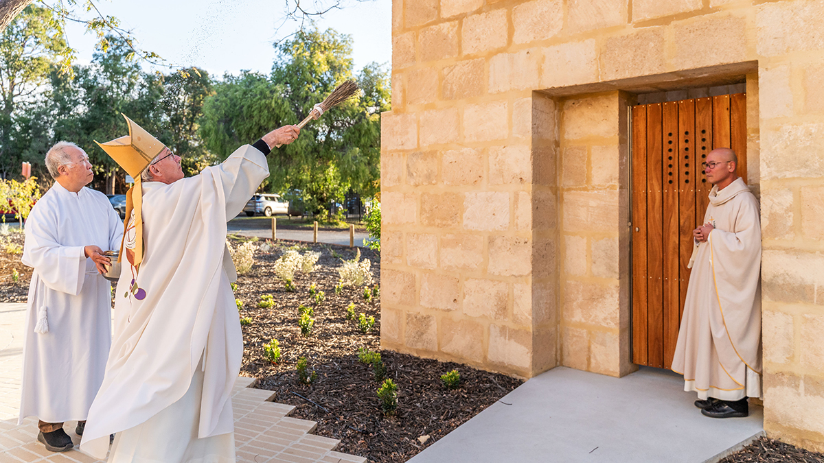 Archbishop Costelloe blesses one of the three limestone towers that are open to the sky. Photo: Supplied/Matt Lim.