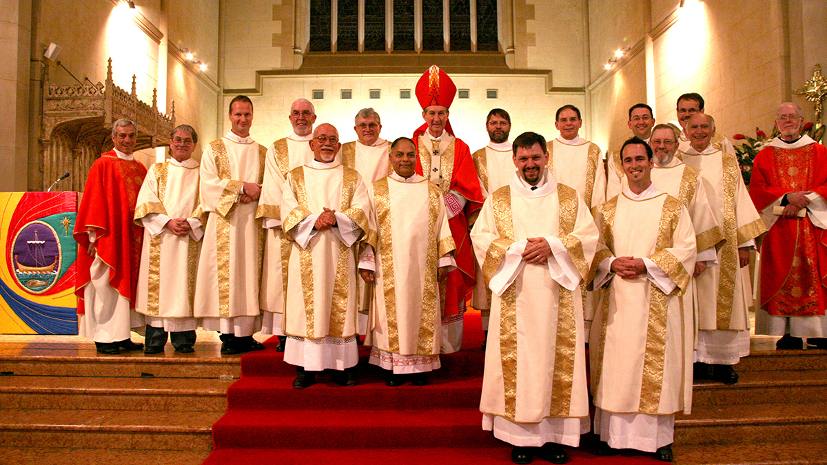The Permanent Deacons following their Ordination to the (Permanent) Diaconate on 29 June 2006 at St Mary’s Cathedral (prior to the renovations), with now Emeritus Archbishop Barry Hickey (centre) and then Office of the Permanent Diaconate Director, Fr Peter Bianchini; Patrick Seatter (now deceased) Greg Lowe, Patrick Moore, Albert Aitkinson, Damian Gorian, Trevor Lyra, Bruce Talbot, Paul Russell, John Kiely, Aaron Peters, Mark Powell, Ivan Sands (now deceased), Paul Stacy and Paul Reid, and former Formator Fr David Barry OSB. Photo: Jamie O’Brien.