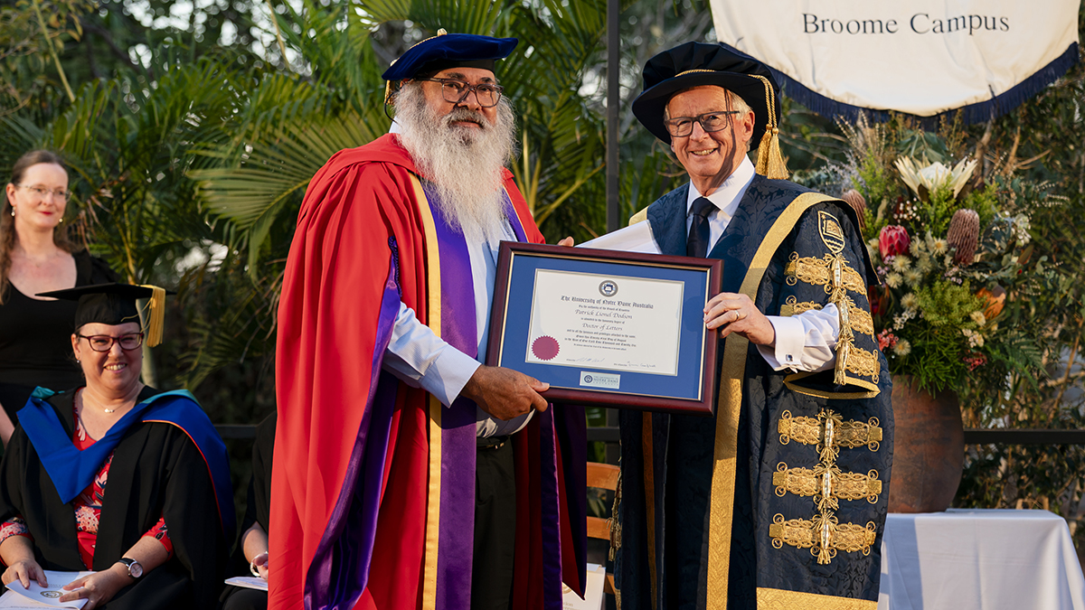 Dr Patrick Dodson is presented with his Honorary Doctor of Letters by UNDA Chancellor Paul McClintock. Photo: Julia Rau/UNDA.
