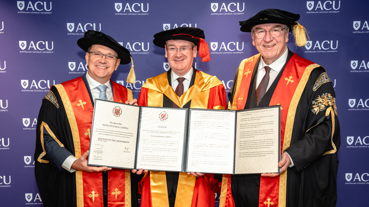 Professor Campbell (centre) accepts his Honorary Doctorate from ACU Vice-Chancellor and President Professor Zlatko Skrbis and ACU Chancellor the Hon Martin Daubney AM KC. Photo: ACU.
